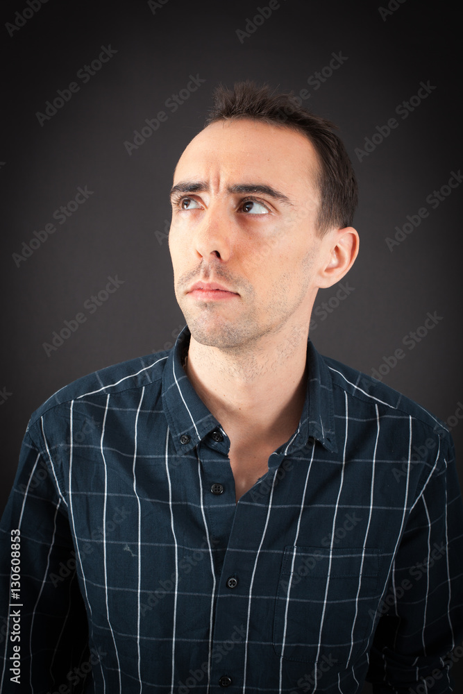 Fototapeta premium Handsome man doing different expressions in different sets of clothes: thinking