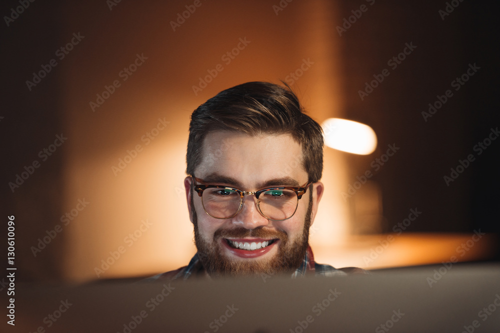 Happy web designer working late at night Happy web designer working late at night