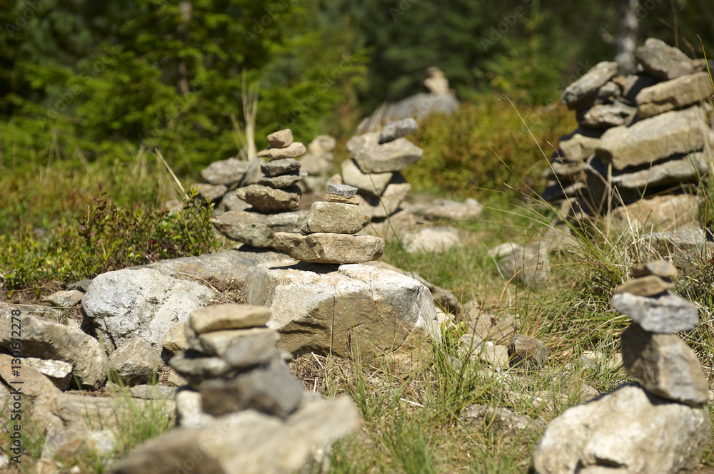 Harmony and balance, poise stones against the forest in the mountains, rock zen sculpture, sunny day Harmony and balance, poise stones against the forest in the mountains, rock zen sculpture, sunny day
