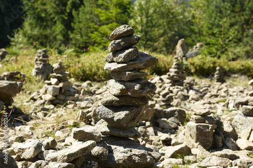 Harmony and balance, poise stones against the forest in the mountains, rock zen sculpture, sunny day