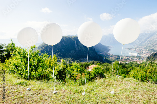 white ballons fly at blue sky