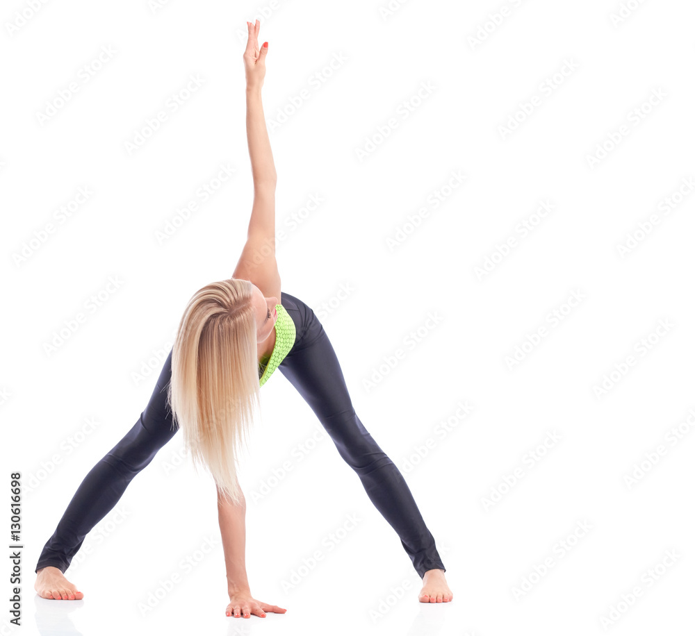 Attractive female gymnast exercising at studio 