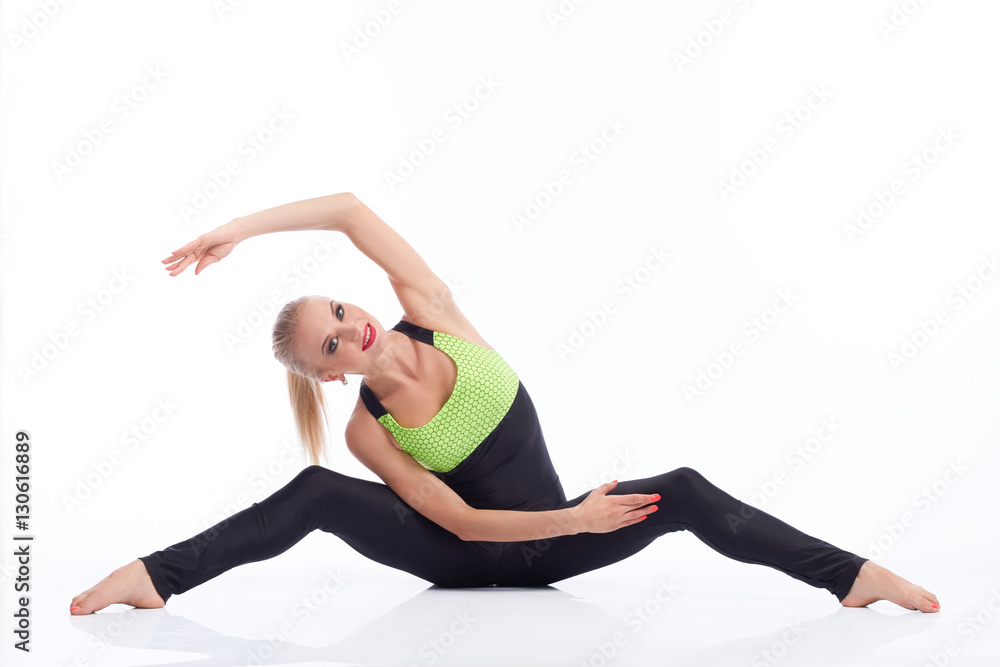 Obraz premium Gorgeous young woman practicing yoga sitting on the floor 