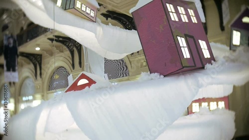 Toy house and road for New Year's and Christmas decorations in the malls, in the central part. Decorations hang ceiling.