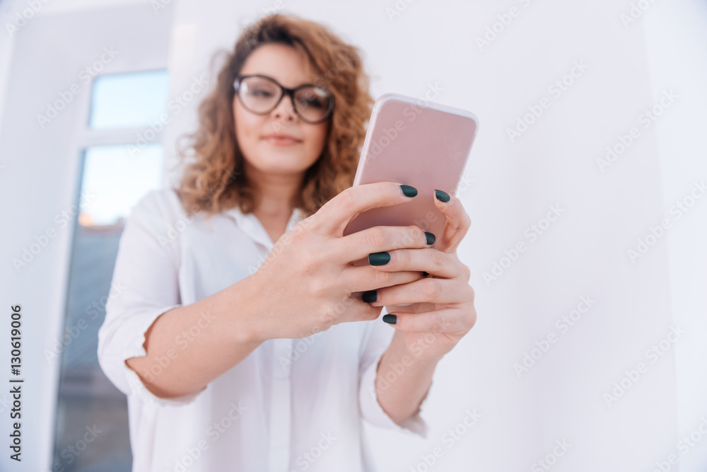 From below image of Woman in shirt making selfie From below image of Woman in shirt making selfie