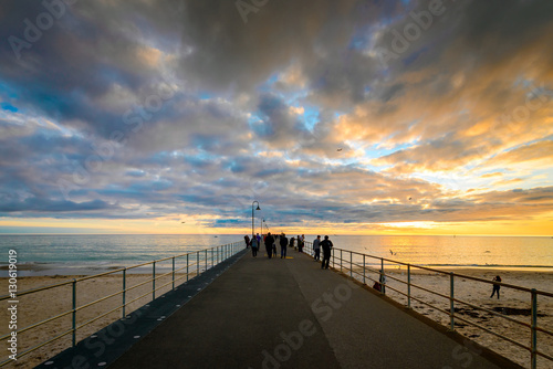 People on Glenelg Beach jetty