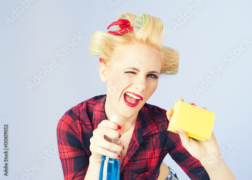 Pin up housewife cleaning with spray photo