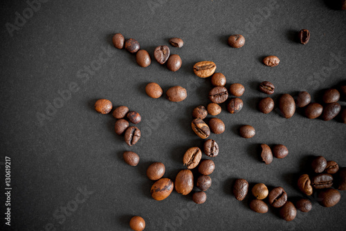 roasted coffee beans over black paper background