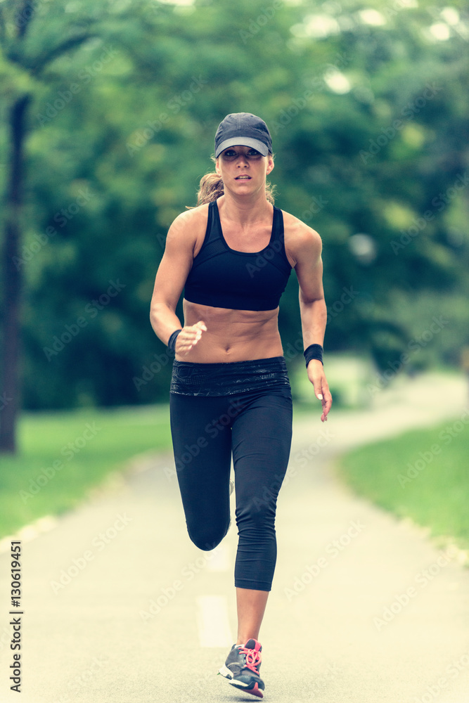 Jogging outdoors. Female athlete jogging outdoors Jogging outdoors. Female athlete jogging outdoors