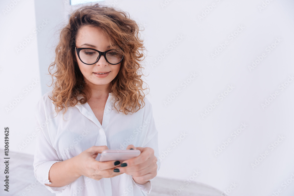 Woman in shirt writing message on phone Woman in shirt writing message on phone