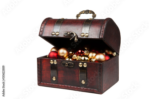 Christmas decorations in an old vintage suitcase isolated on white