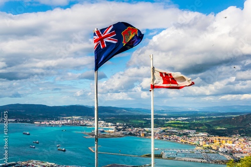 Flags of gibraltar with landscape on background.