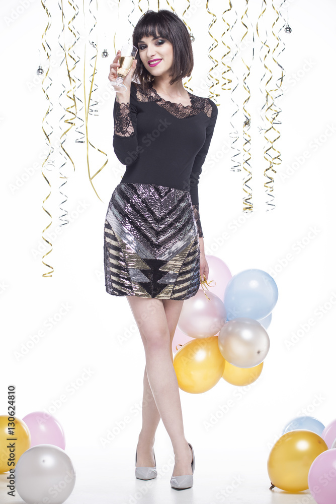 Fototapeta premium Beautiful woman elegantly dressed drinking champagne at the event