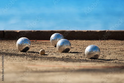 Metallic petanque four balls and a small wood jack photo