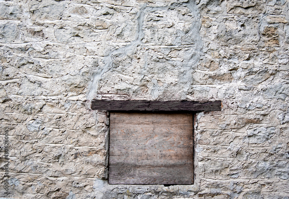 Old concrete and stone building with window and lintel Old concrete and stone building with window and lintel