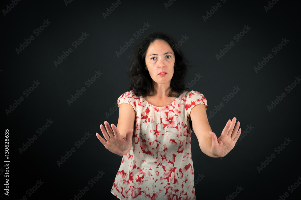 Beautiful woman doing different expressions in different sets of clothes: stop sign Beautiful woman doing different expressions in different sets of clothes: stop sign