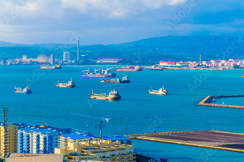 Cargo ships are approaching a port in the algeciras bay in spain.