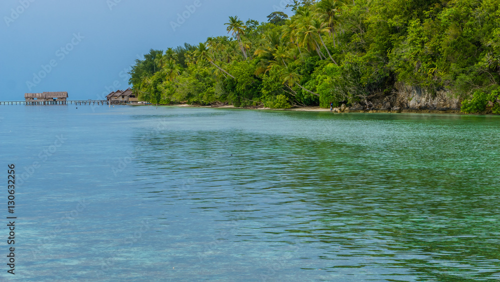Bay with Underwater Corals in Front of Diving Station and Guesthouses on Kri Island, Raja Ampat, Indonesia, West Papua Bay with Underwater Corals in Front of Diving Station and Guesthouses on Kri Island, Raja Ampat, Indonesia, West Papua