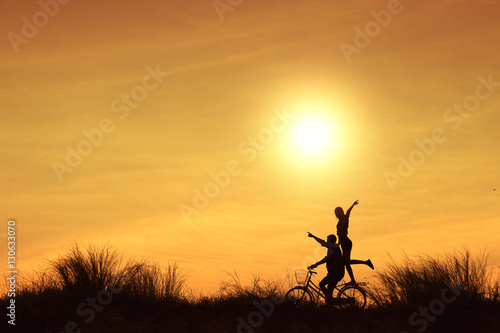 couple on a bicycle at sunset