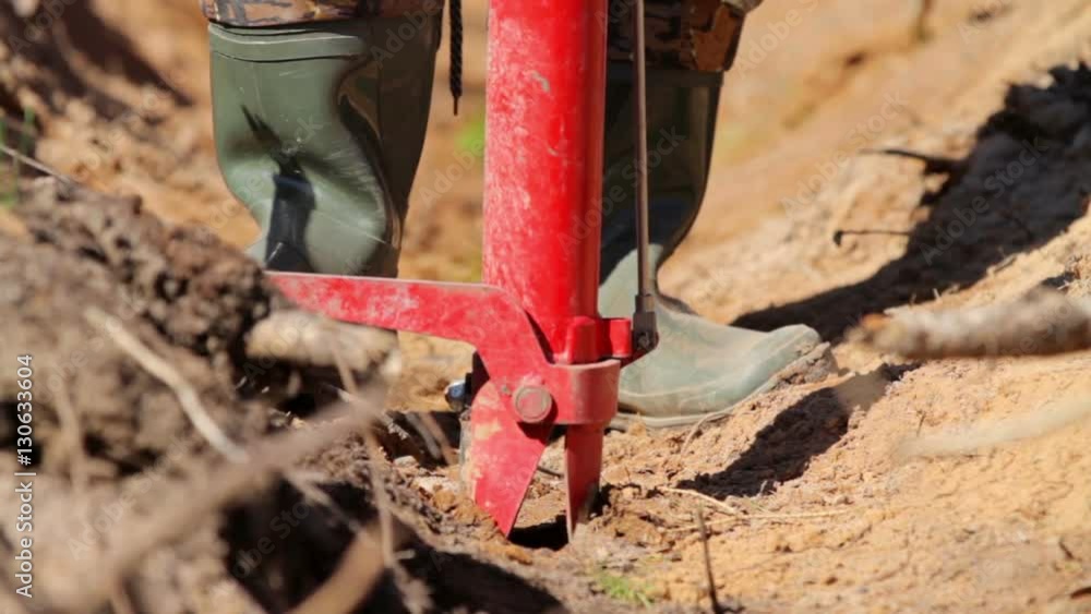 Man planting tree sprout with special equipment Man planting tree sprout with special equipment