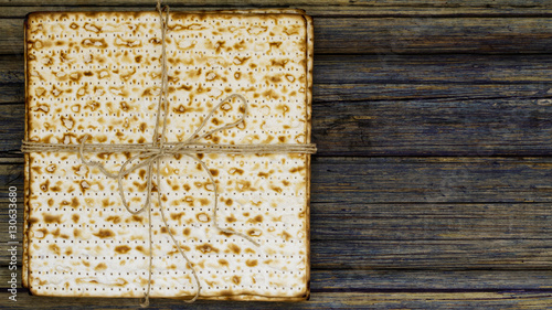 Stack of matzah or matza on a vintage wood background presented photo