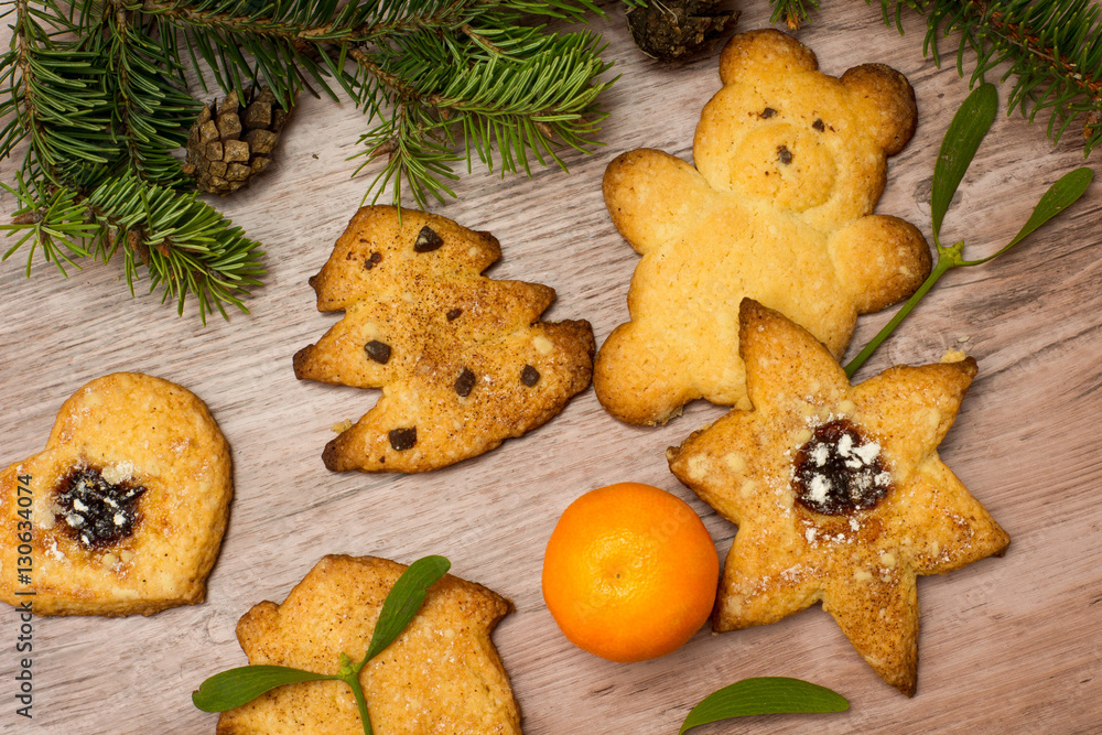 Fototapeta premium grandma's special christmas cookies among mistletoe, mandarin and christmas tree branches