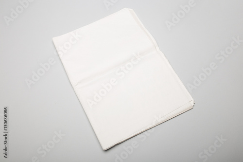 Folded newspapers on gray background