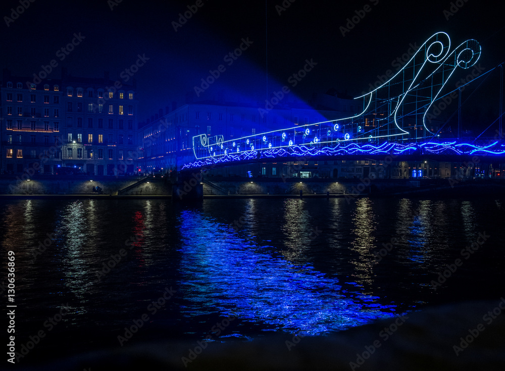 Fototapeta premium Lyon - France - Fete de Lumieres in December 2016 - Festival of lights. A bridge transformed in a ship, and the oars are made of blue light.