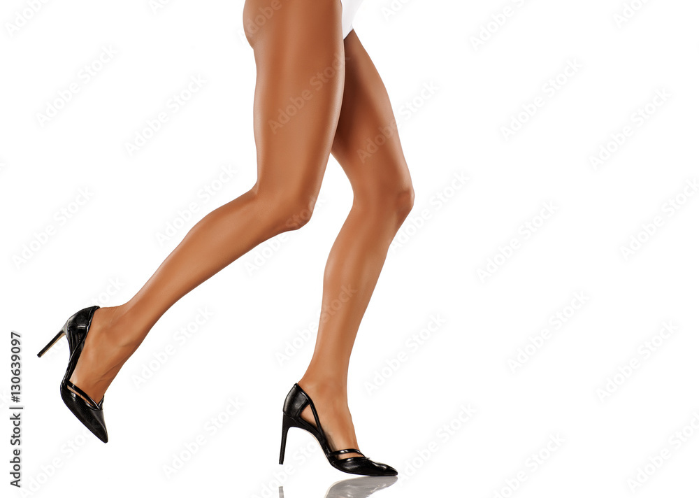 elegant, beautifully shaped and cared woman's legs in black shoes elegant, beautifully shaped and cared woman's legs in black shoes
