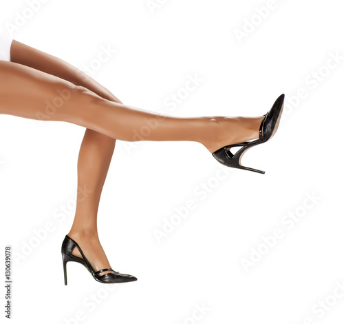 elegant  beautifully shaped and cared woman s legs in black shoes