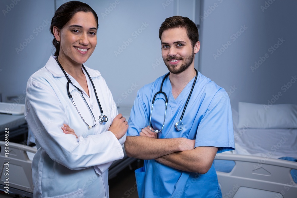 Portrait of male nurse and doctor standing in ward Portrait of male nurse and doctor standing in ward