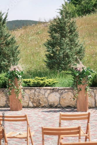 Rustic wedding decorations for the ceremony outside in sunny weather