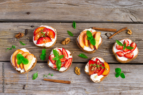 Summer colorful bruschetta appetizer with fruit, curd cheese and Fototapet