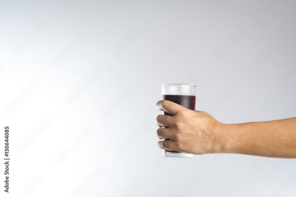 Hand holding a glass of soda water Hand holding a glass of soda water