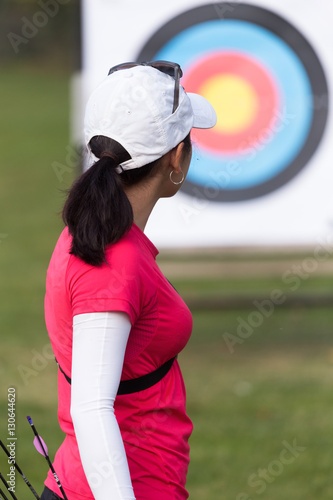 Female athlete practicing archery in stadium