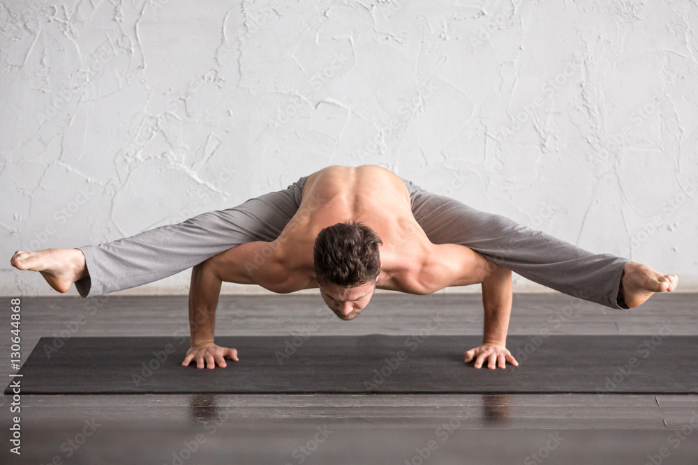 Fototapeta premium A man doing yoga exercises