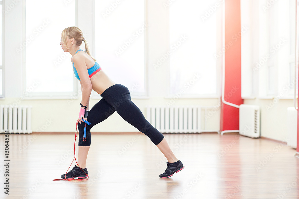 Young slim woman jumping with skipping rope in gym. Young slim woman jumping with skipping rope in gym.