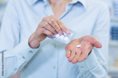 Pharmacist taking pills in pharmacy © WavebreakMediaMicro
