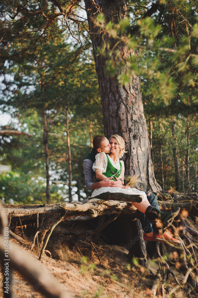 man and woman sitting on a tree  the roots