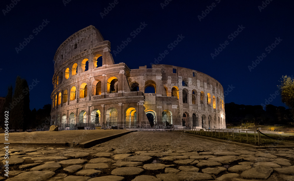 Colosseum in Rome at night lit up from the inside