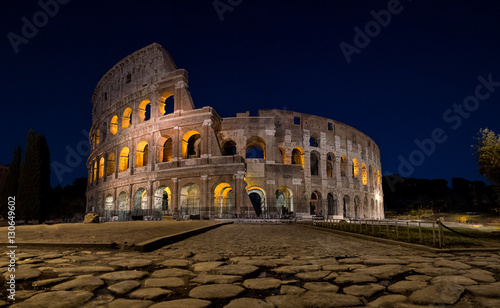Photography Colosseum in Rome at night lit up from the inside
