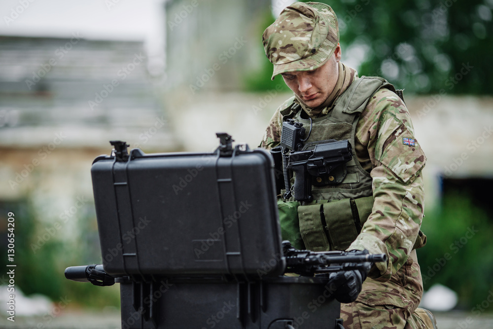 Soldiers with guncasel  in destroyed city. Military