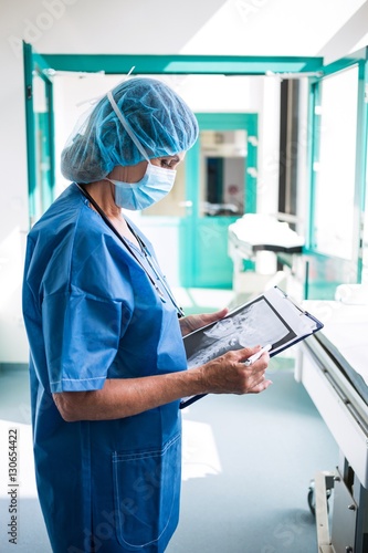 Surgeon examining an x-ray