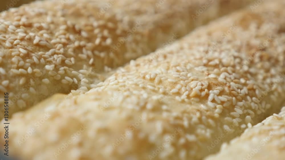 Slow tilt over filled and baked thin sheets of dough with sesame 4K 2160p 30fps UHD footage - Filo pie with cheese and spinach after baking 3840X2160 UltraHD tilting video Slow tilt over filled and baked thin sheets of dough with sesame 4K 2160p 30fps UHD footage - Filo pie with cheese and spinach after baking 3840X2160 UltraHD tilting video