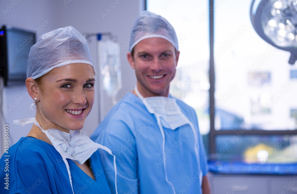 Portrait of male and female nurse smiling in operation theater Portrait of male and female nurse smiling in operation theater