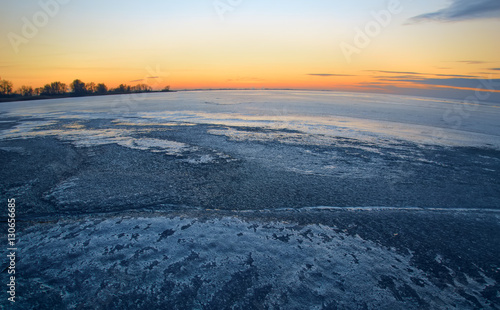 the frozen body of water at dusk