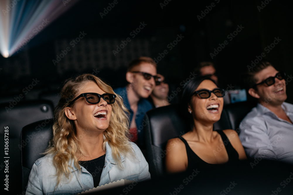 Friends watching 3d movie and laughing Friends watching 3d movie and laughing