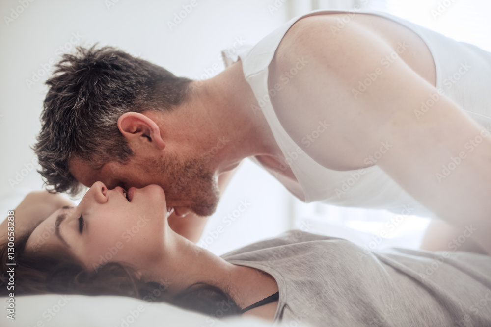 Passionate and romantic couple enjoying foreplay - obrazy, fototapety, plakaty 