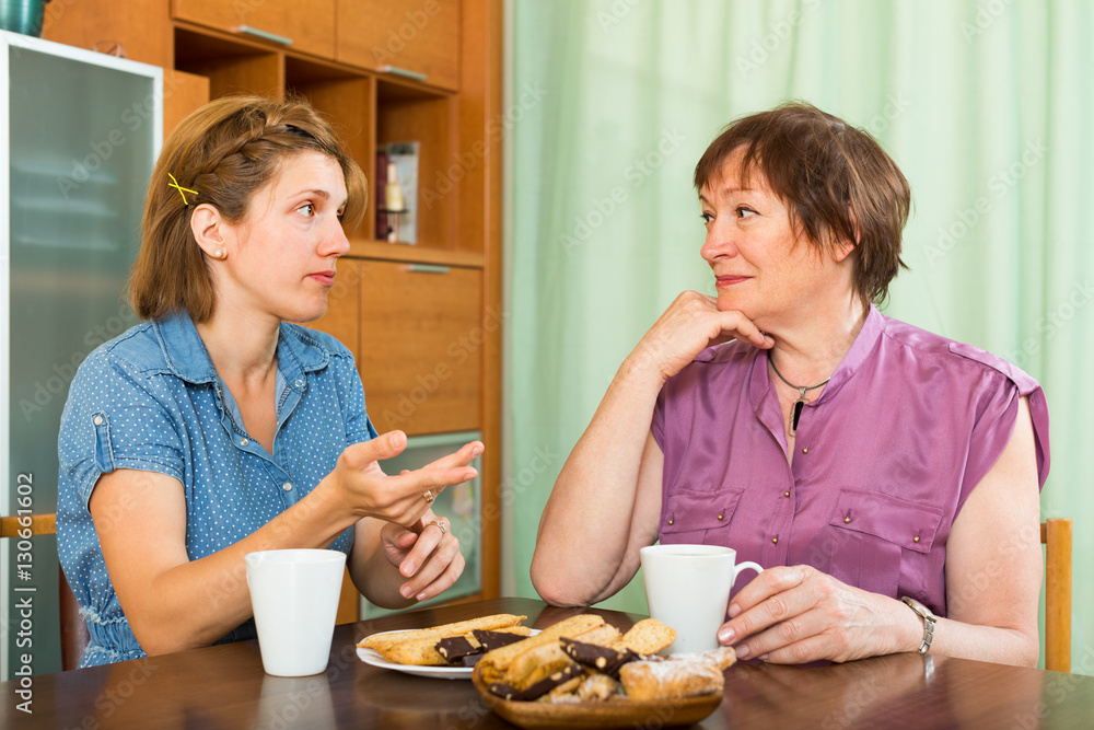 Mother and daughter drinking tea