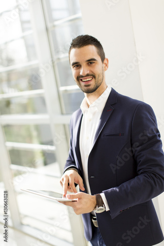 Businessman using his digital tablet at the office